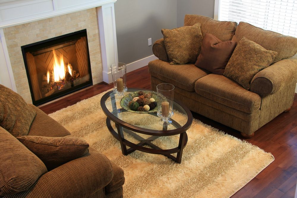 A Cozy Living Room With a Lit Fireplace — Unger Air in Manilla, NSW