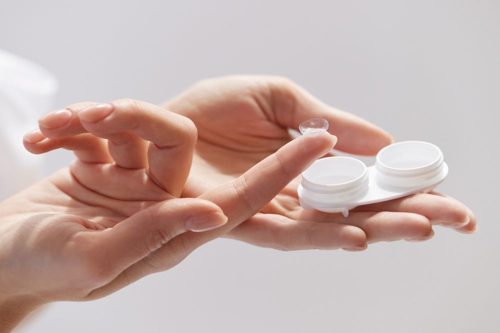 A Person Is Holding A Pair Of Contact Lenses In Their Hands — Eye Supply In Mareeba, QLD