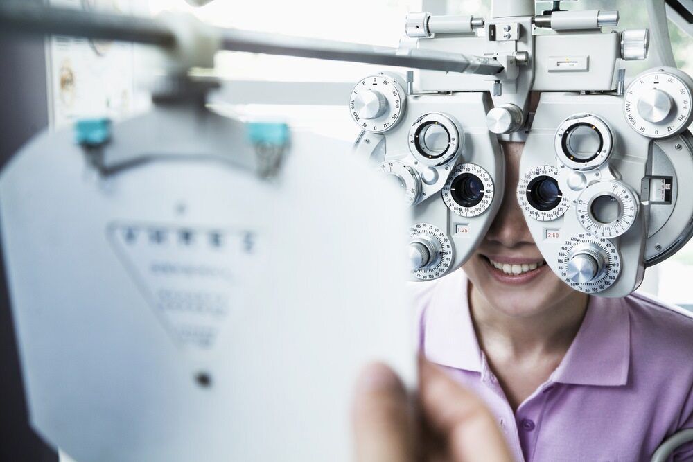 A Woman Is Getting Her Eyes Checked By An Ophthalmologist — Eye Supply In Mareeba, QLD