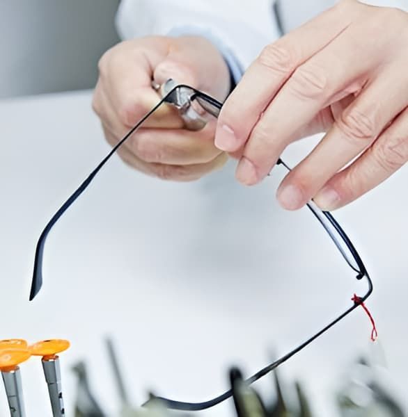 A Person Is Holding A Pair Of Glasses In Their Hands — Eye Supply In Mareeba, QLD