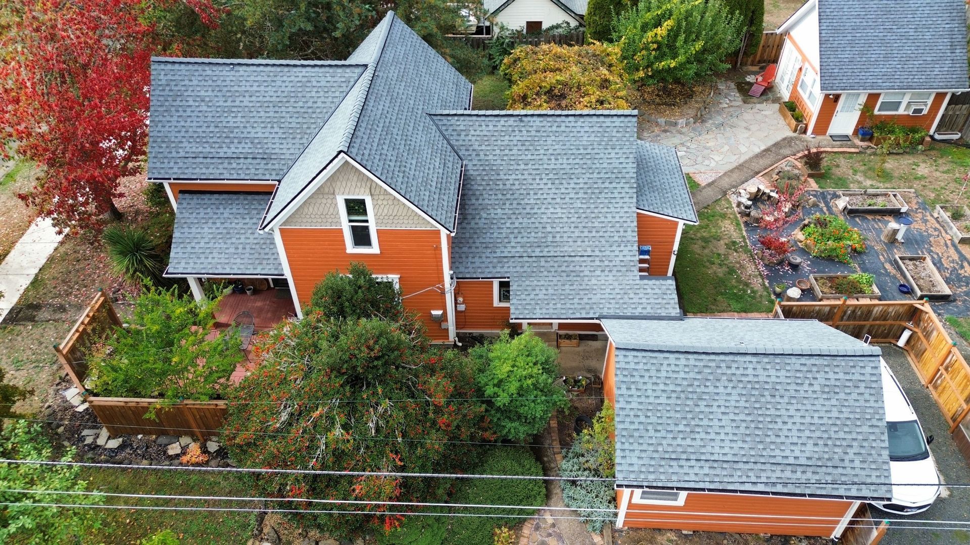 An aerial view of a house with a car parked in front of it.