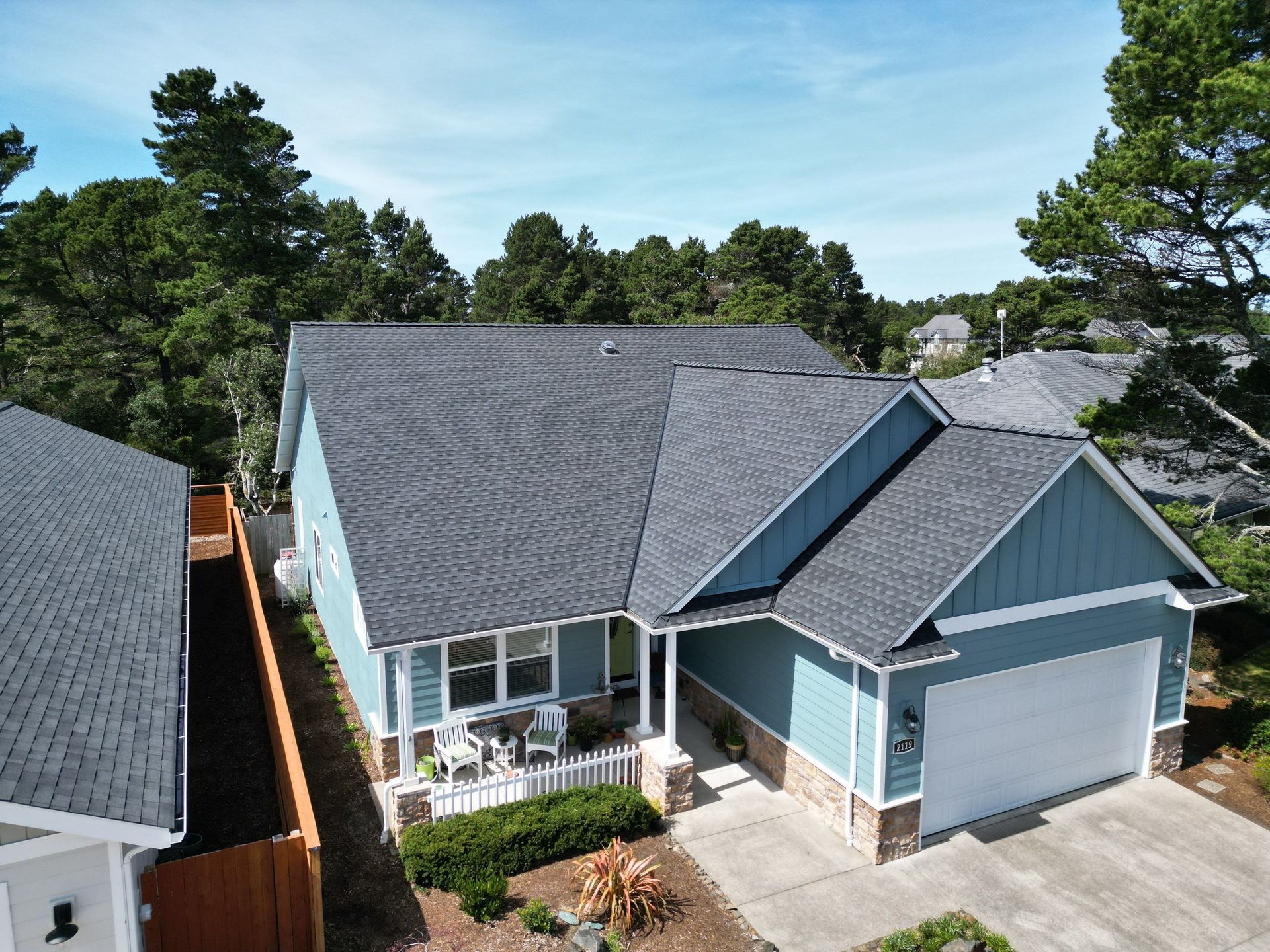 An aerial view of a house with a gray roof