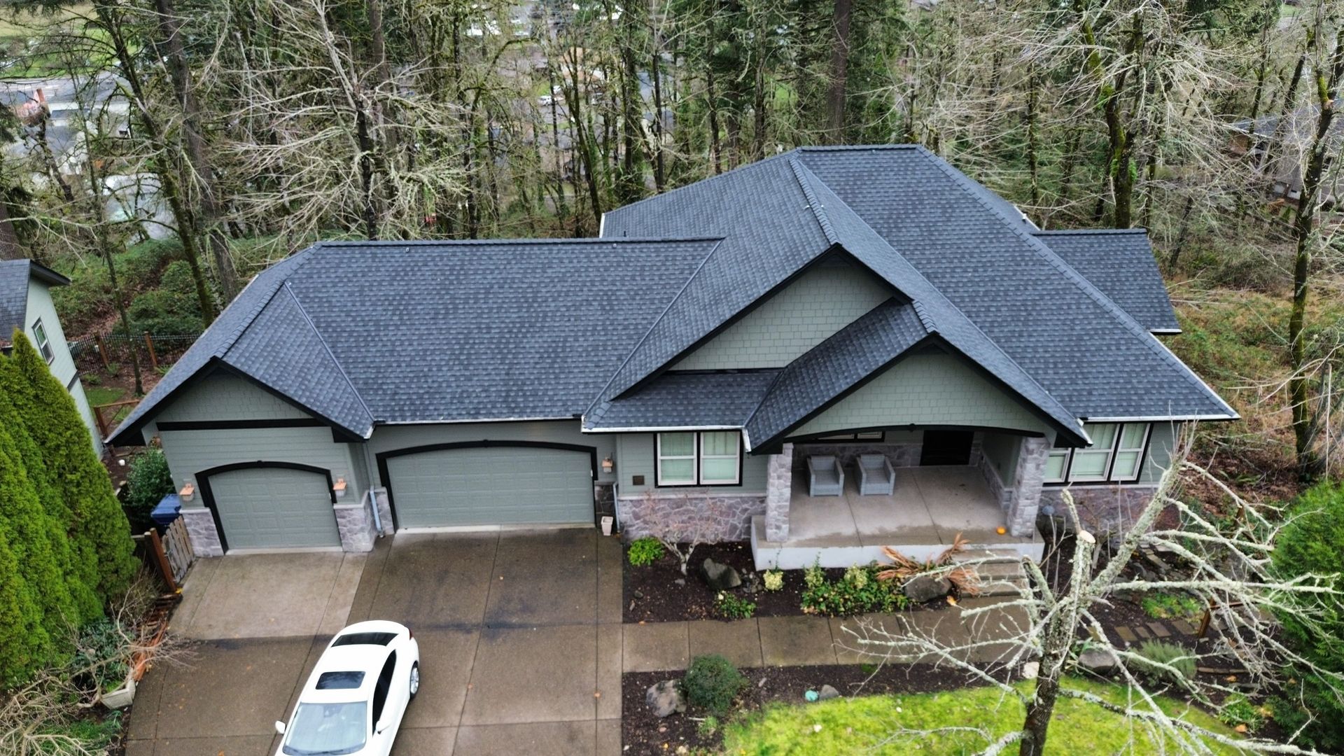 An aerial view of a house with a car parked in front of it.