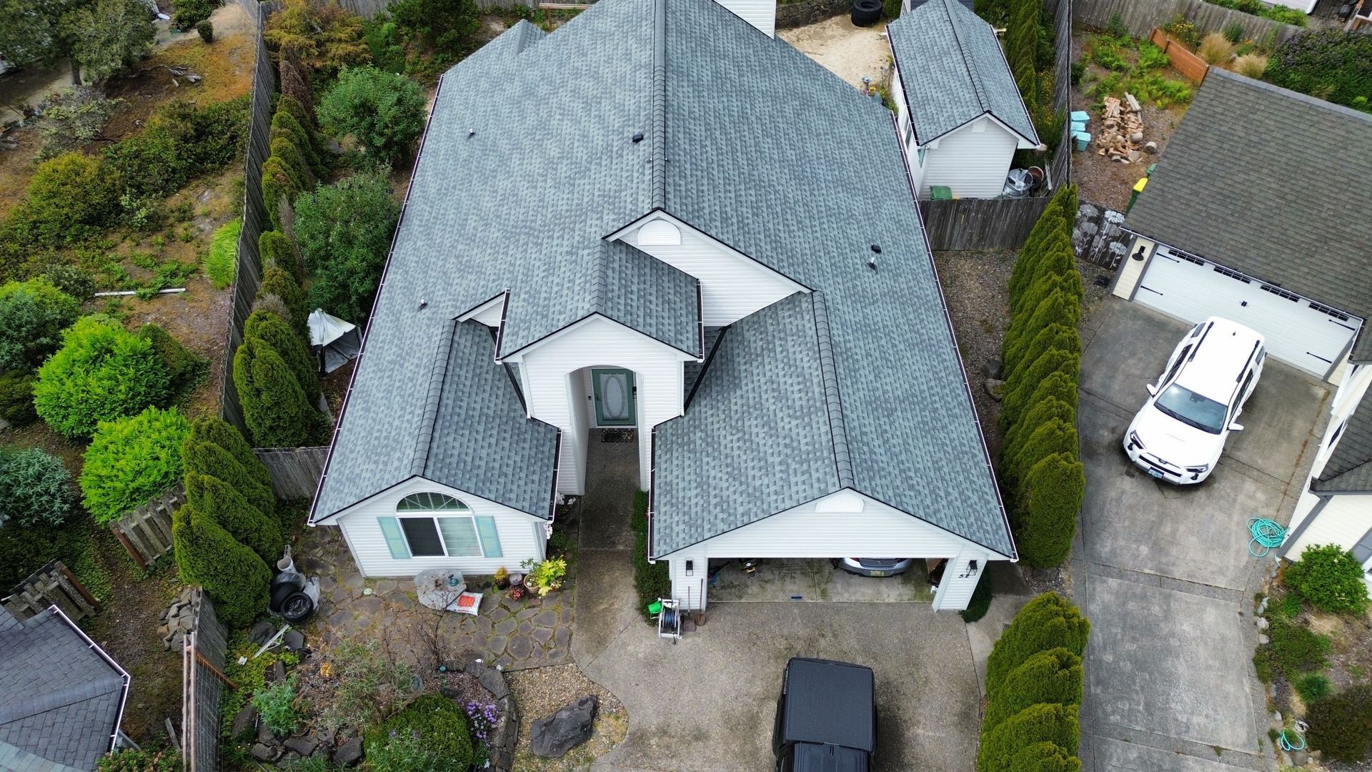 An aerial view of a large house with a gray roof.