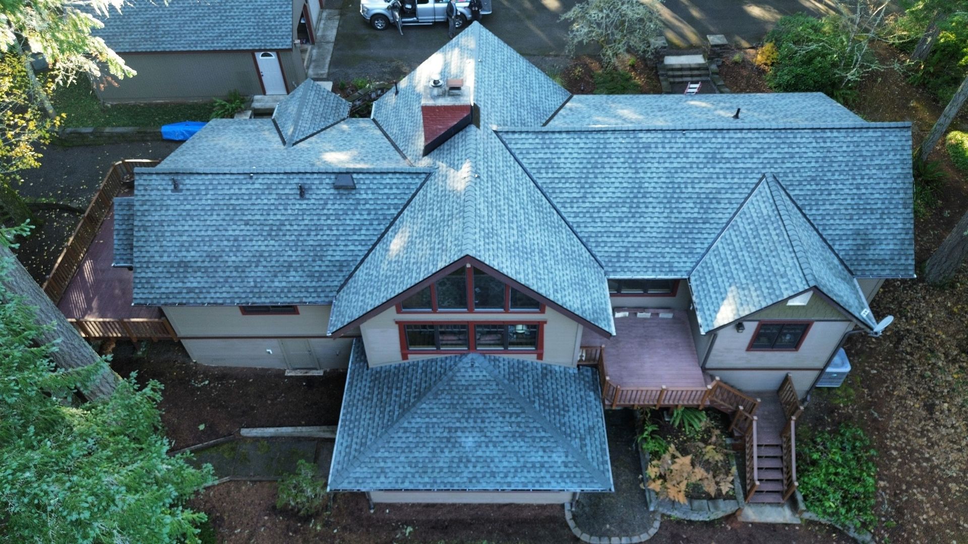 An aerial view of a large house with a gray roof