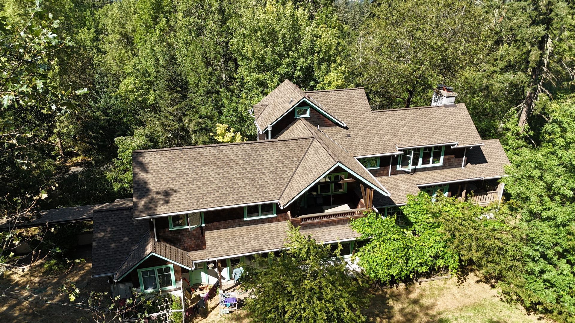 An aerial view of a large house surrounded by trees.