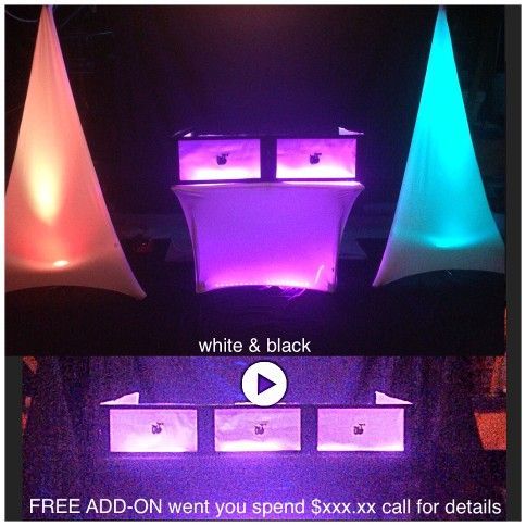 DJ booth with colorful up-lighting and fabric decorations. White and black furniture. 
