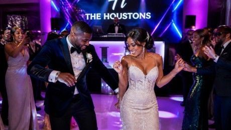 Couple dancing at a purple-lit reception with “The Houstons” sign in the background