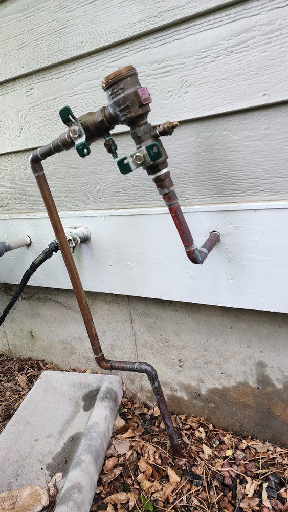 A close up of a faucet on the side of a house.