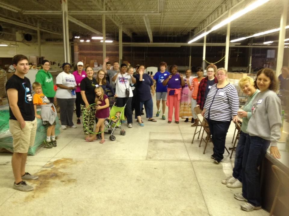 A large group of people are standing in a room