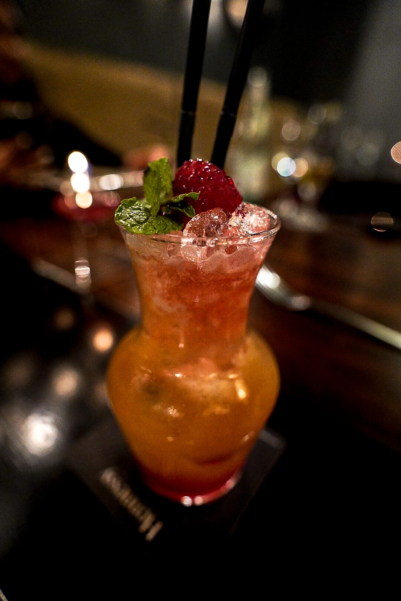 A close up of a drink in a vase on a table