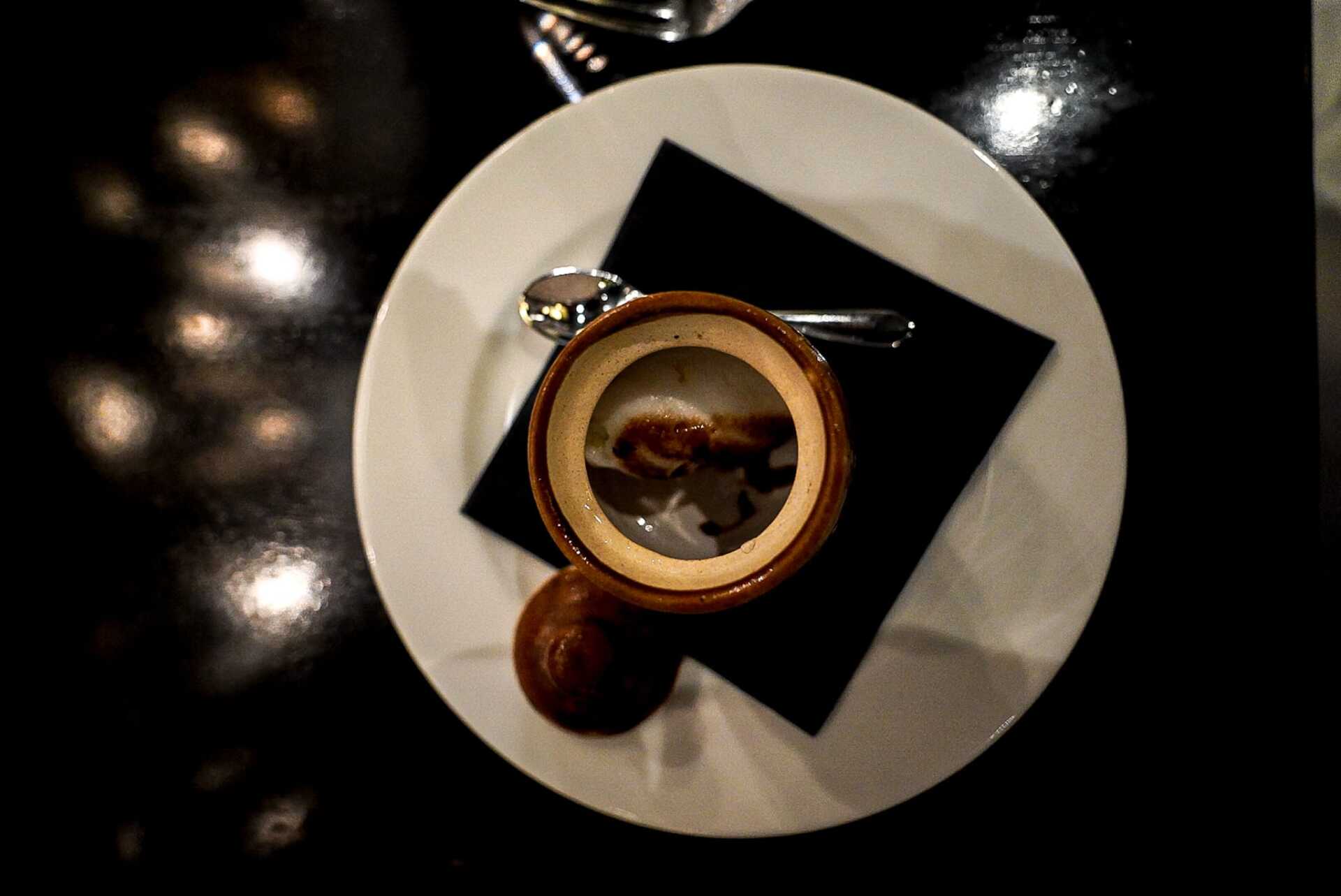 A white plate with a bowl of food on it