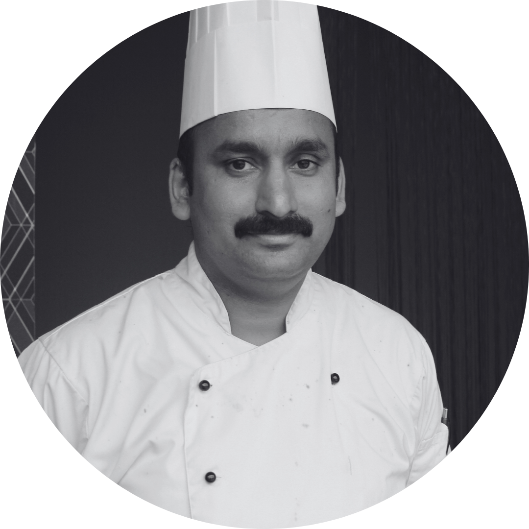 A black and white photo of a chef in a circle