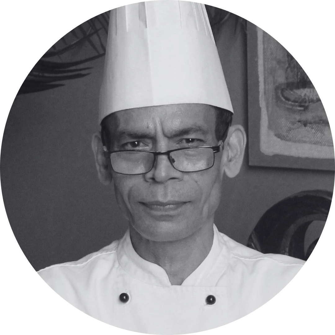 A black and white photo of a chef wearing glasses and a chef 's hat