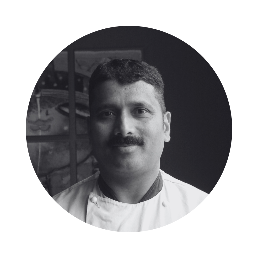A black and white photo of a man with a mustache