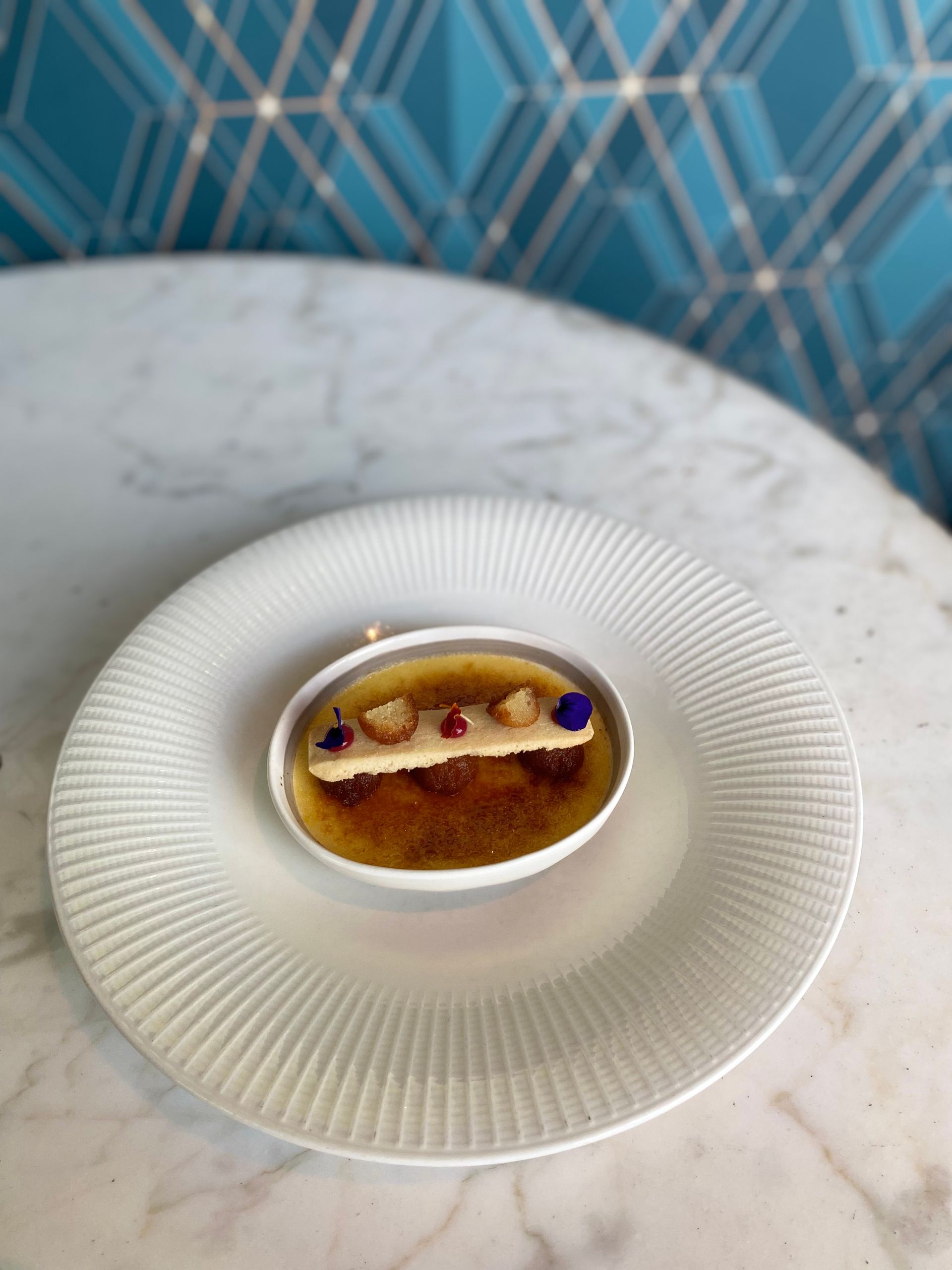 A white plate topped with a dessert on a table.