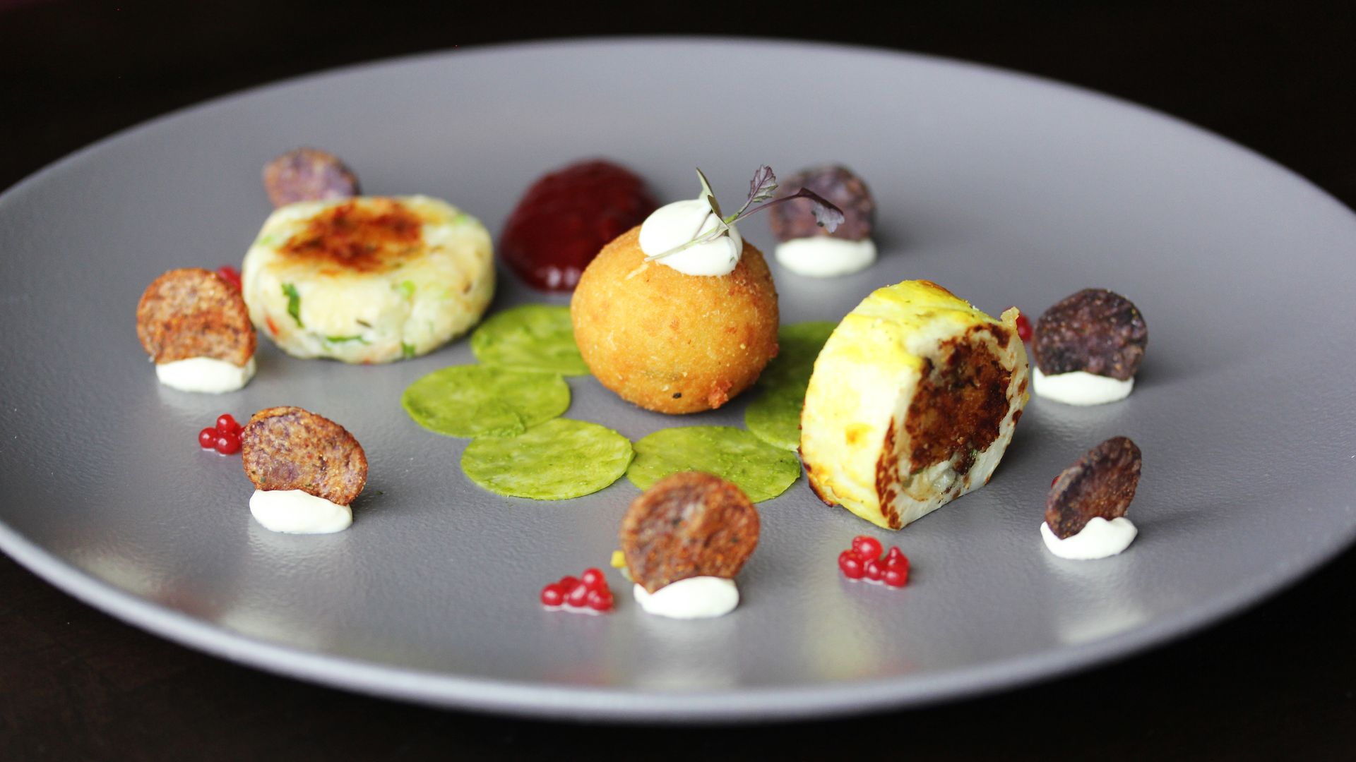 A plate of food on a table with a black background