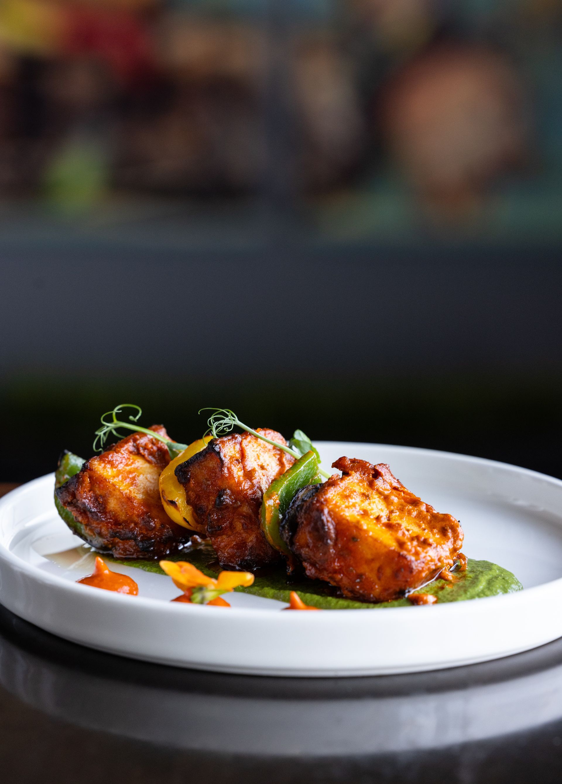 A bowl of food is sitting on a wooden tray.