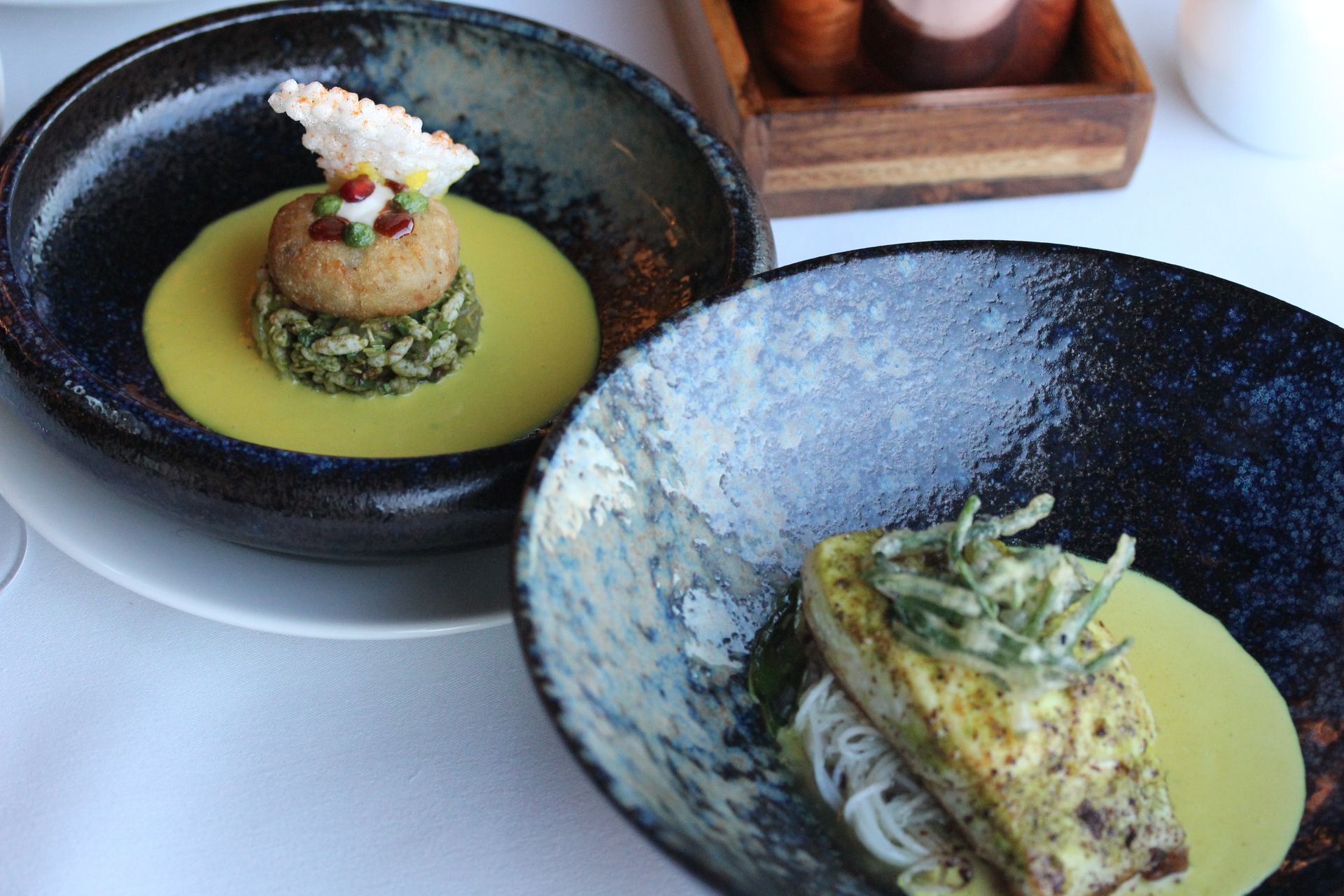 Two bowls of food are sitting next to each other on a table.