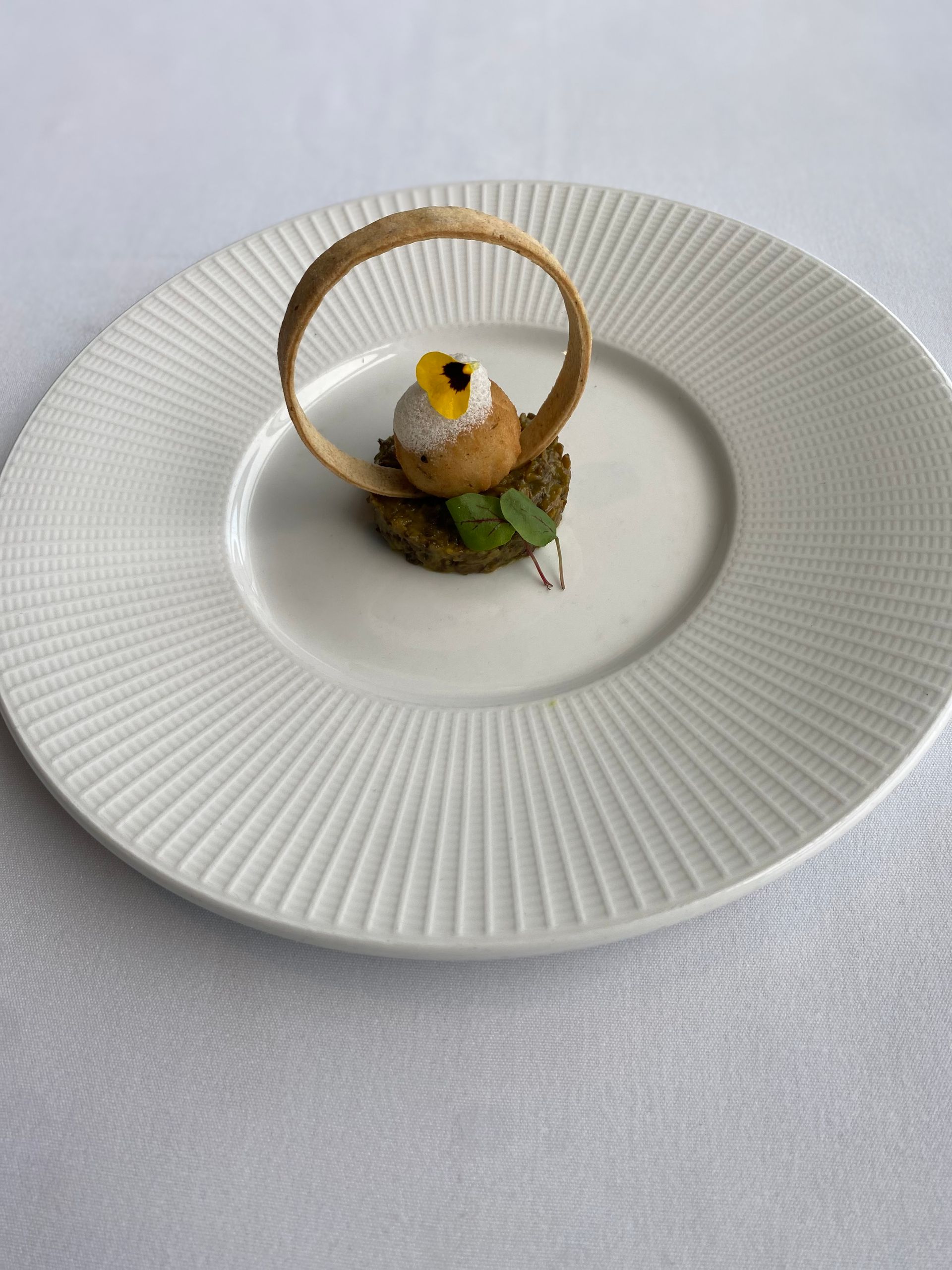 A white plate with a dessert on it on a table.