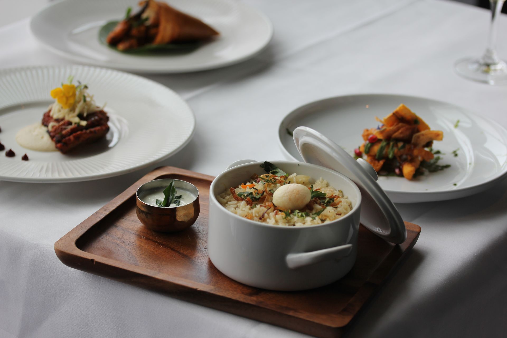 A bowl of food is sitting on a wooden tray on a table.