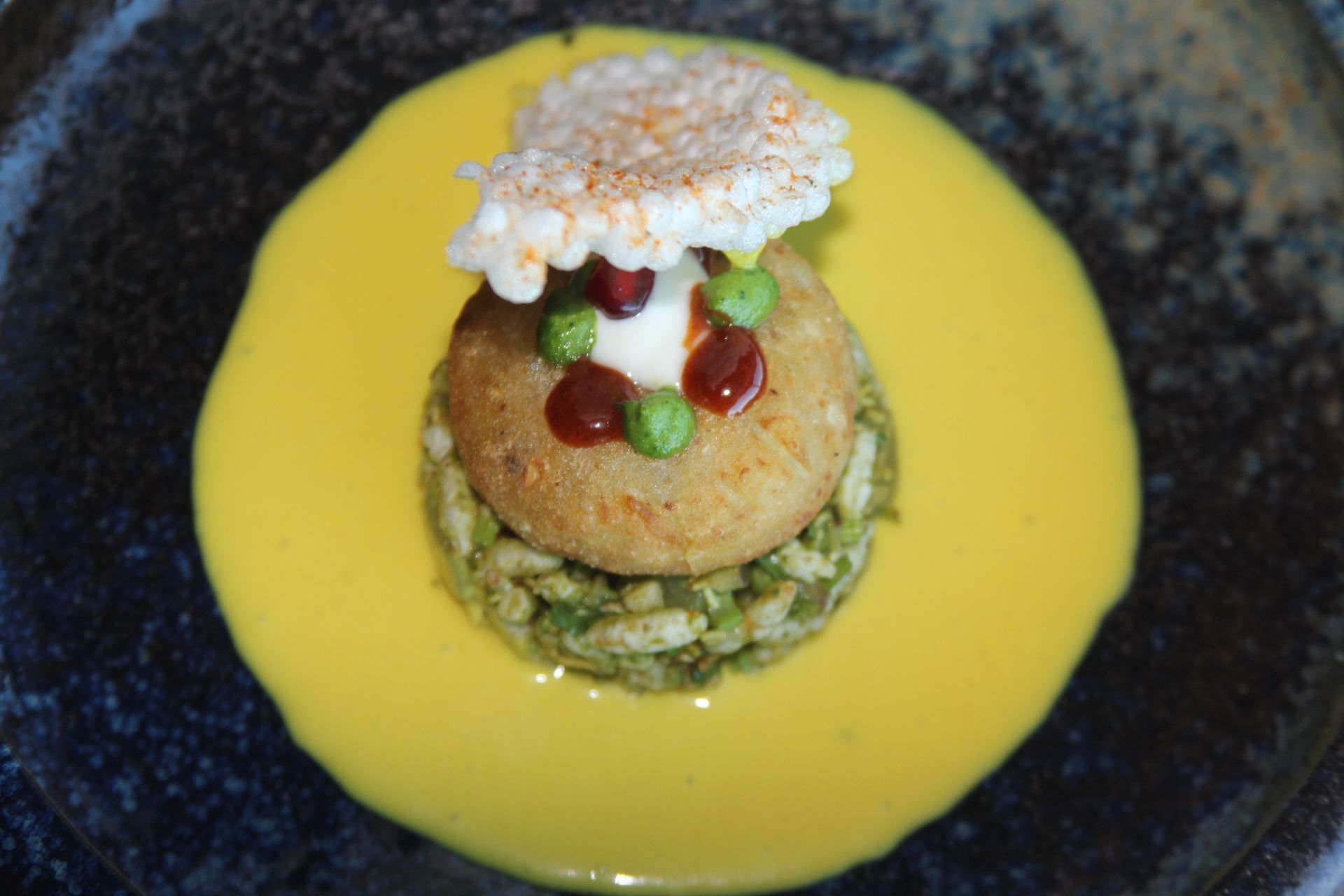 A close up of a plate of food with a yellow sauce