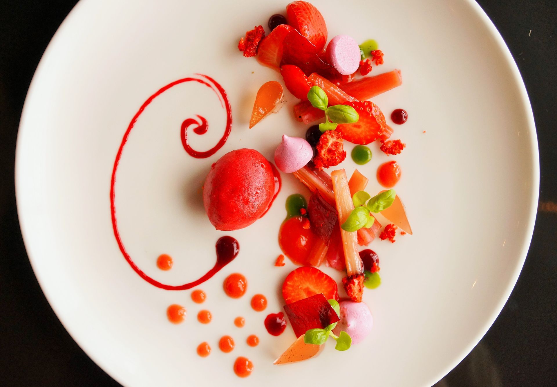 A white plate topped with strawberries and other fruits