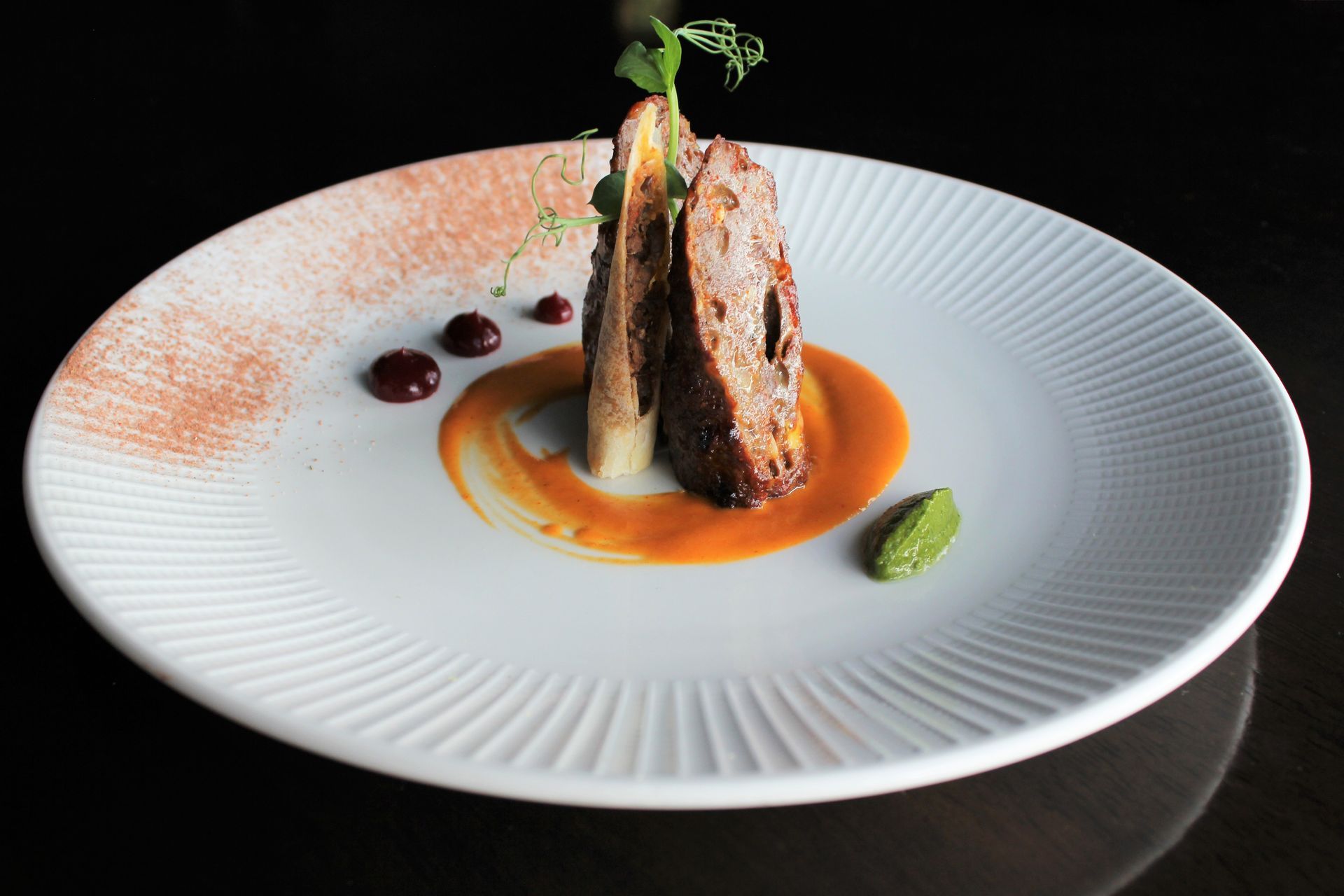 A white plate with a piece of meat on it