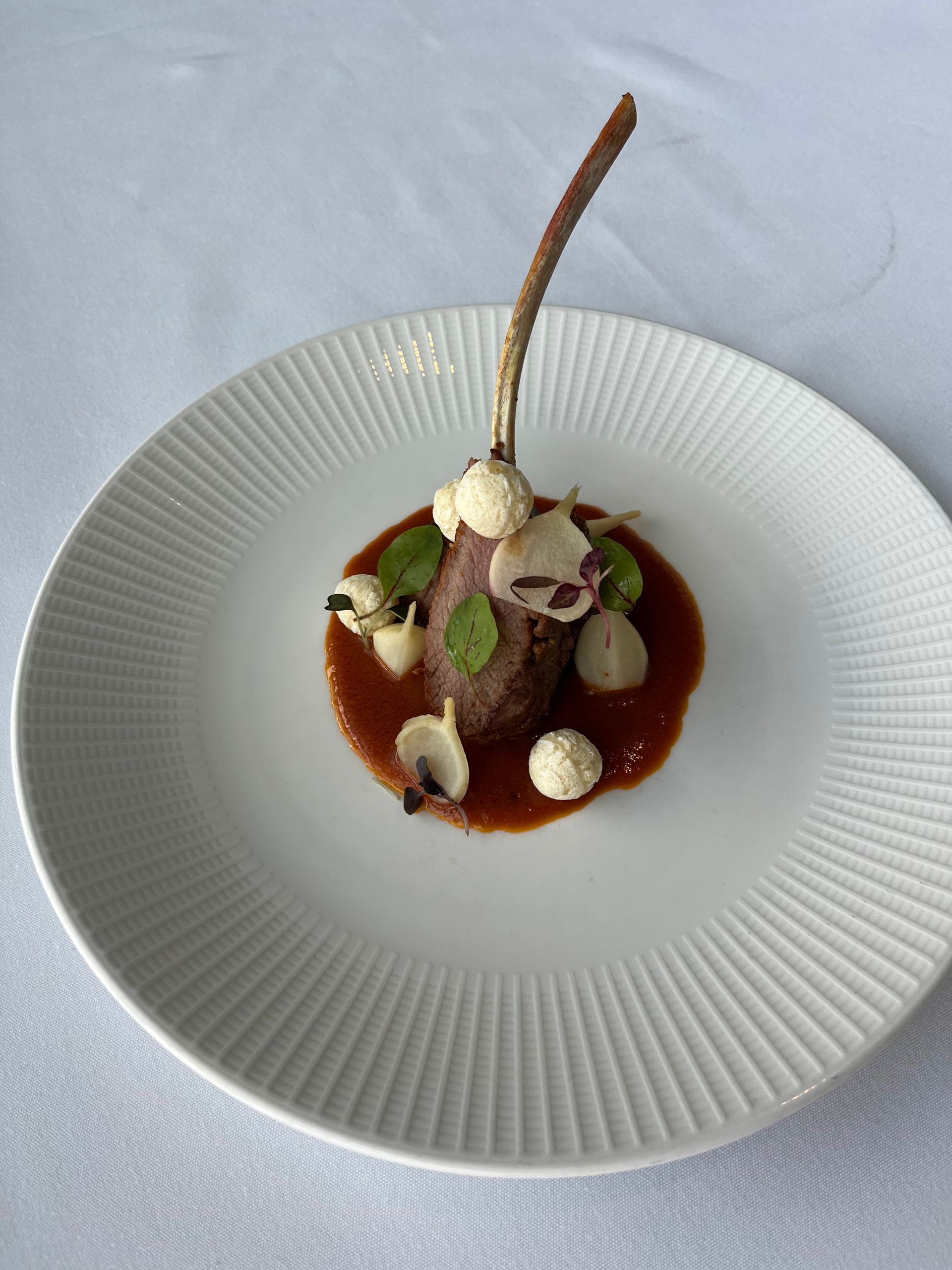 A white plate with a piece of food on it