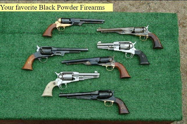 Several black powder firearms are displayed on a green mat