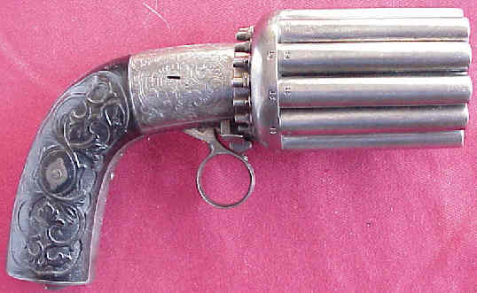 A close up of a revolver on a pink surface.