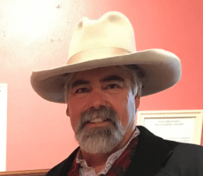 A man with a beard wearing a cowboy hat