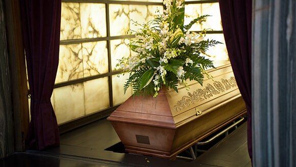 Urn, Candle And A Picture Frame On A Table — Quality Cremation Services in Rockhampton, QLD