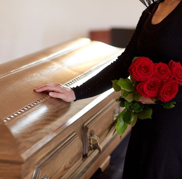 Woman Mourning On The Deceased Person — Quality Cremation Services in Rockhampton, QLD