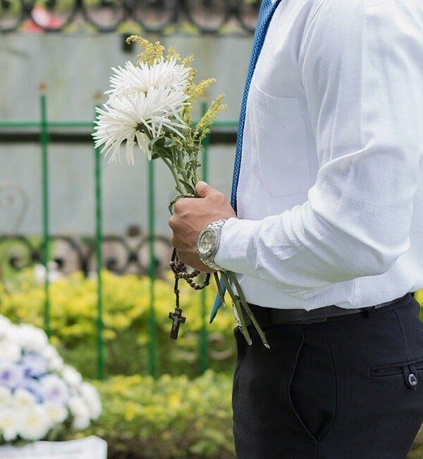 Man Holding Flowers — Quality Cremation Services in Rockhampton, QLD