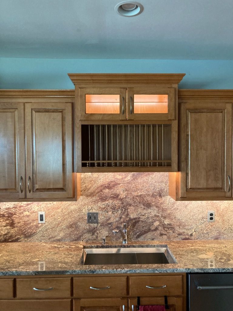 a kitchen with wooden cabinets and a stainless steel sink
