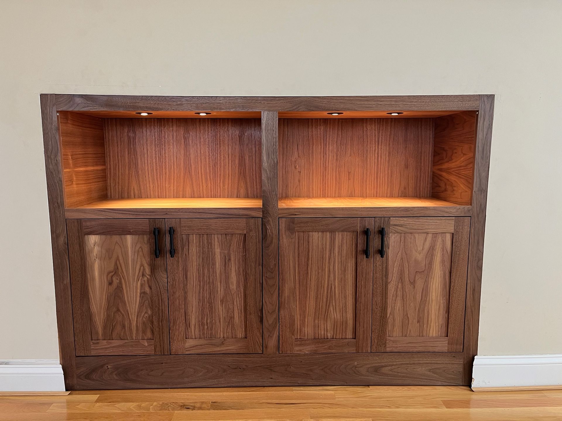 A wooden cabinet with a light on top of it