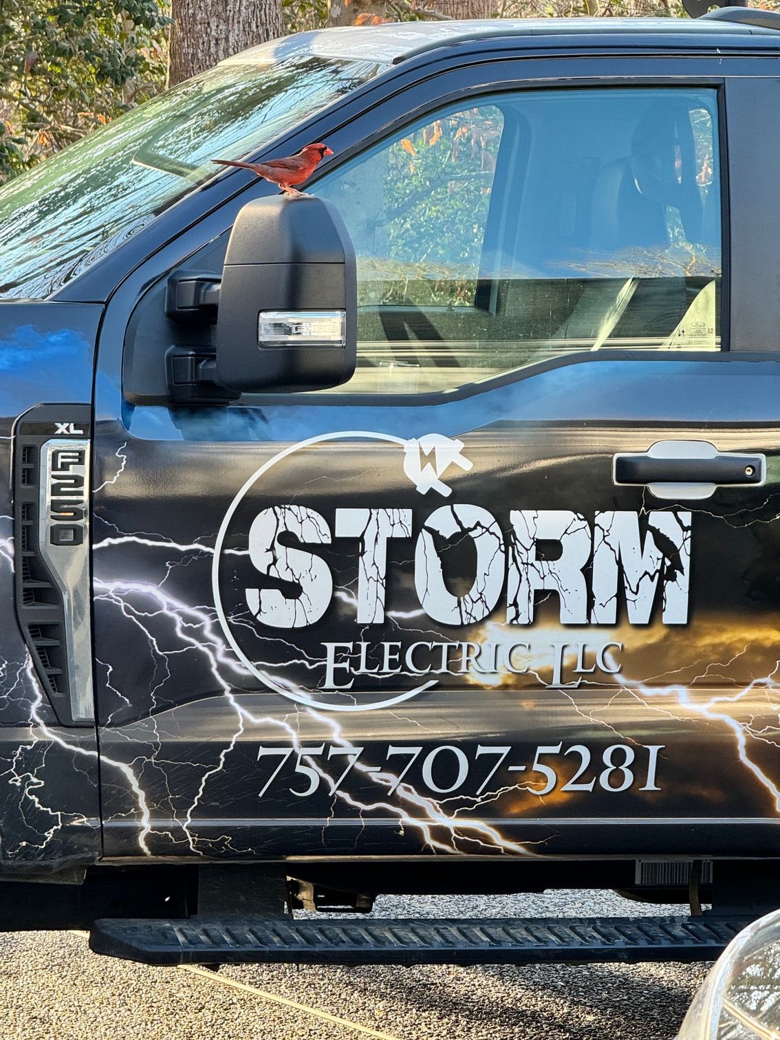A storm electric truck is parked in a parking lot.