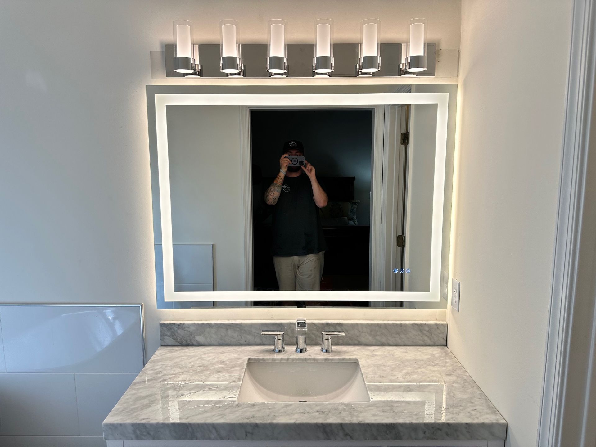 A man is taking a picture of himself in a bathroom mirror.