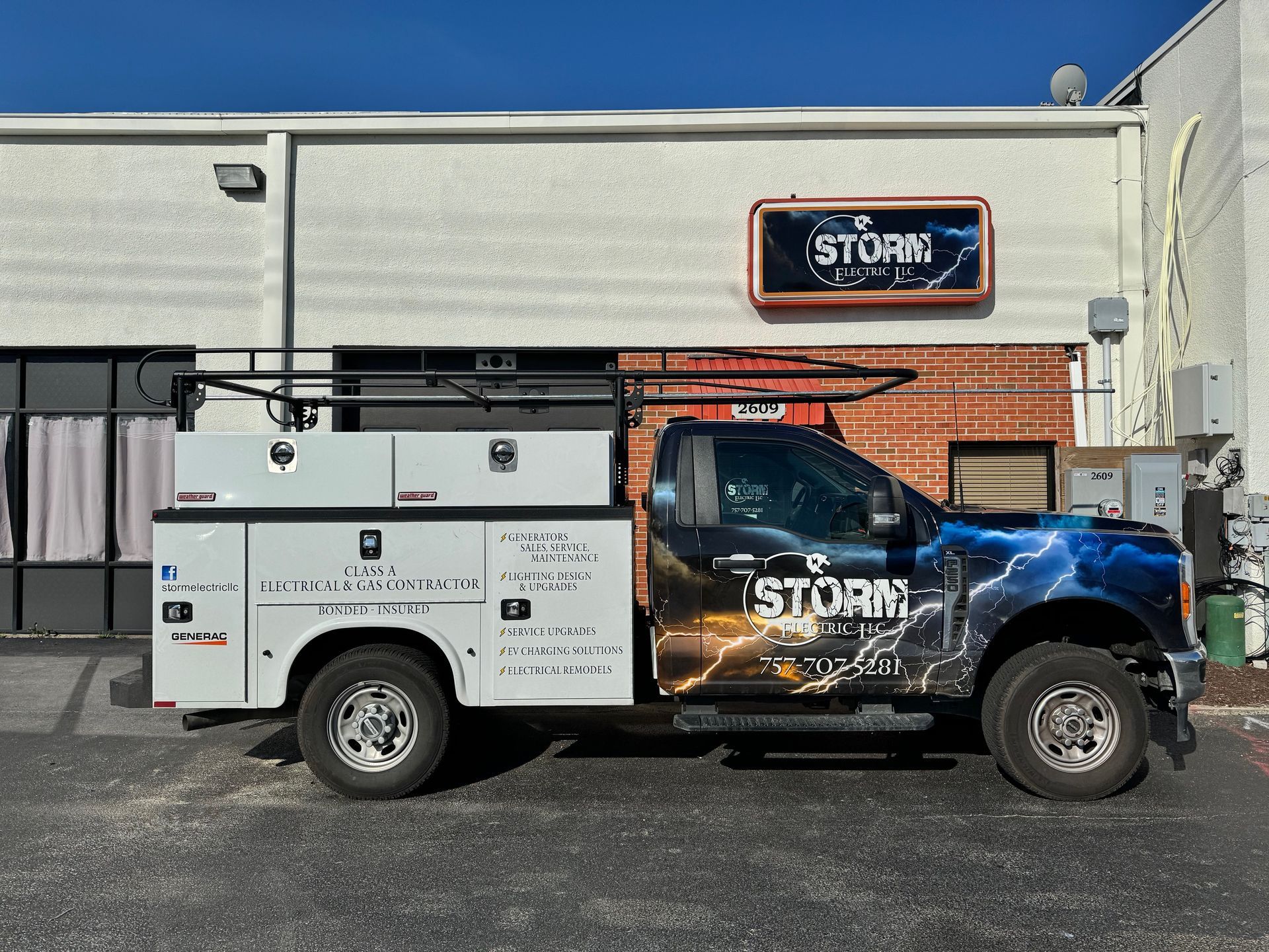 a storm truck is parked in front of a building .