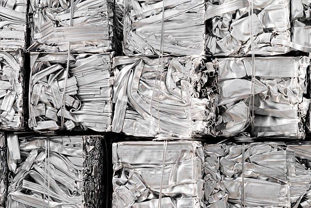 A pile of crushed aluminum blocks stacked on top of each other.