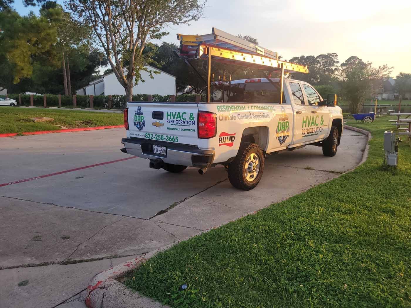 A white truck is parked on the side of the road.