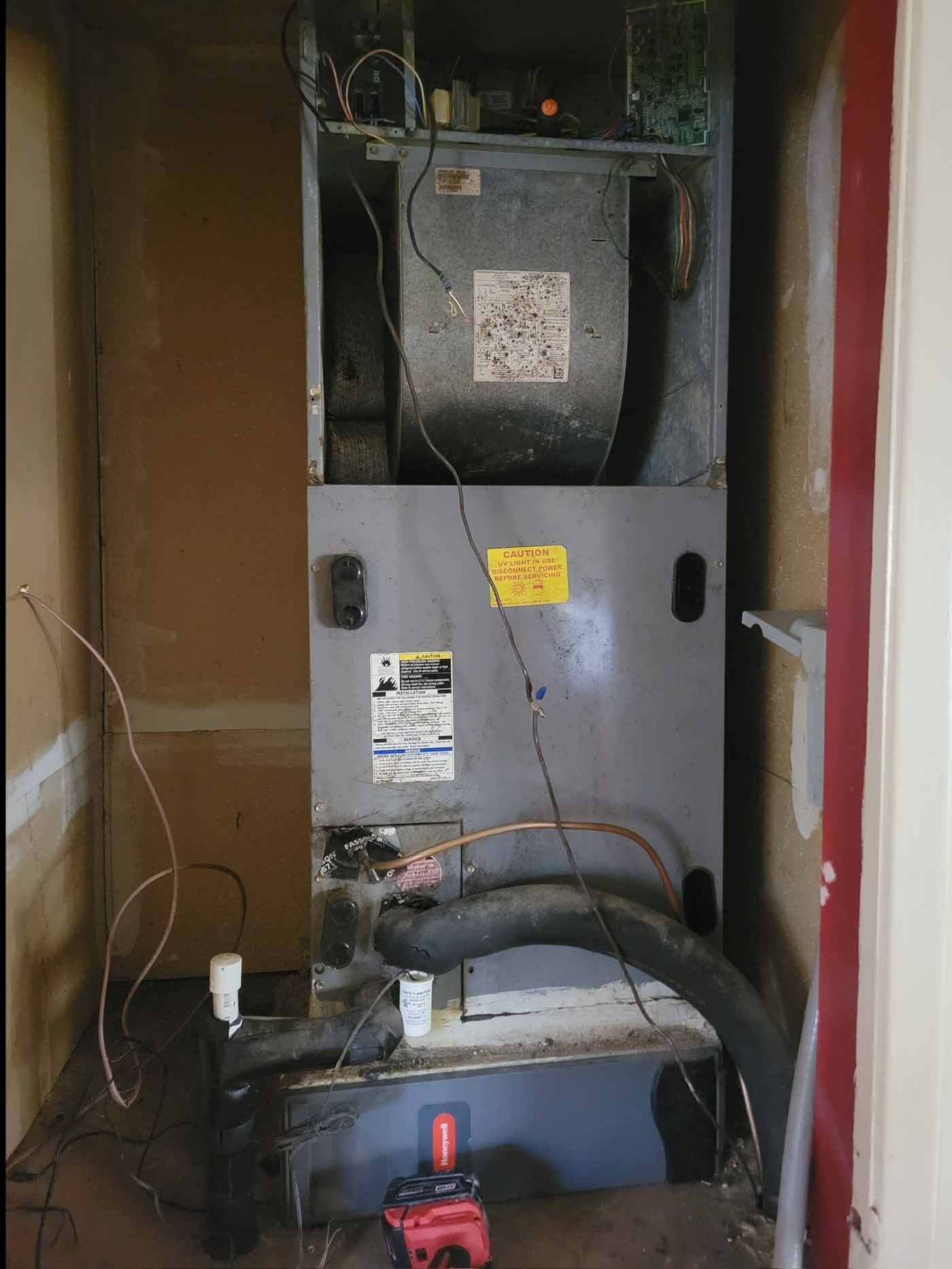 A room with a heater and a drill in it