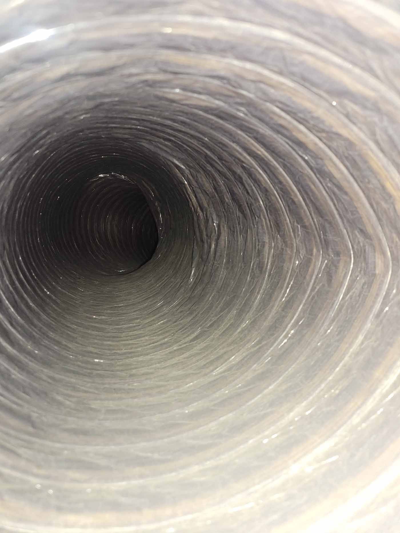 A close up of the inside of a duct with a hole in the middle.