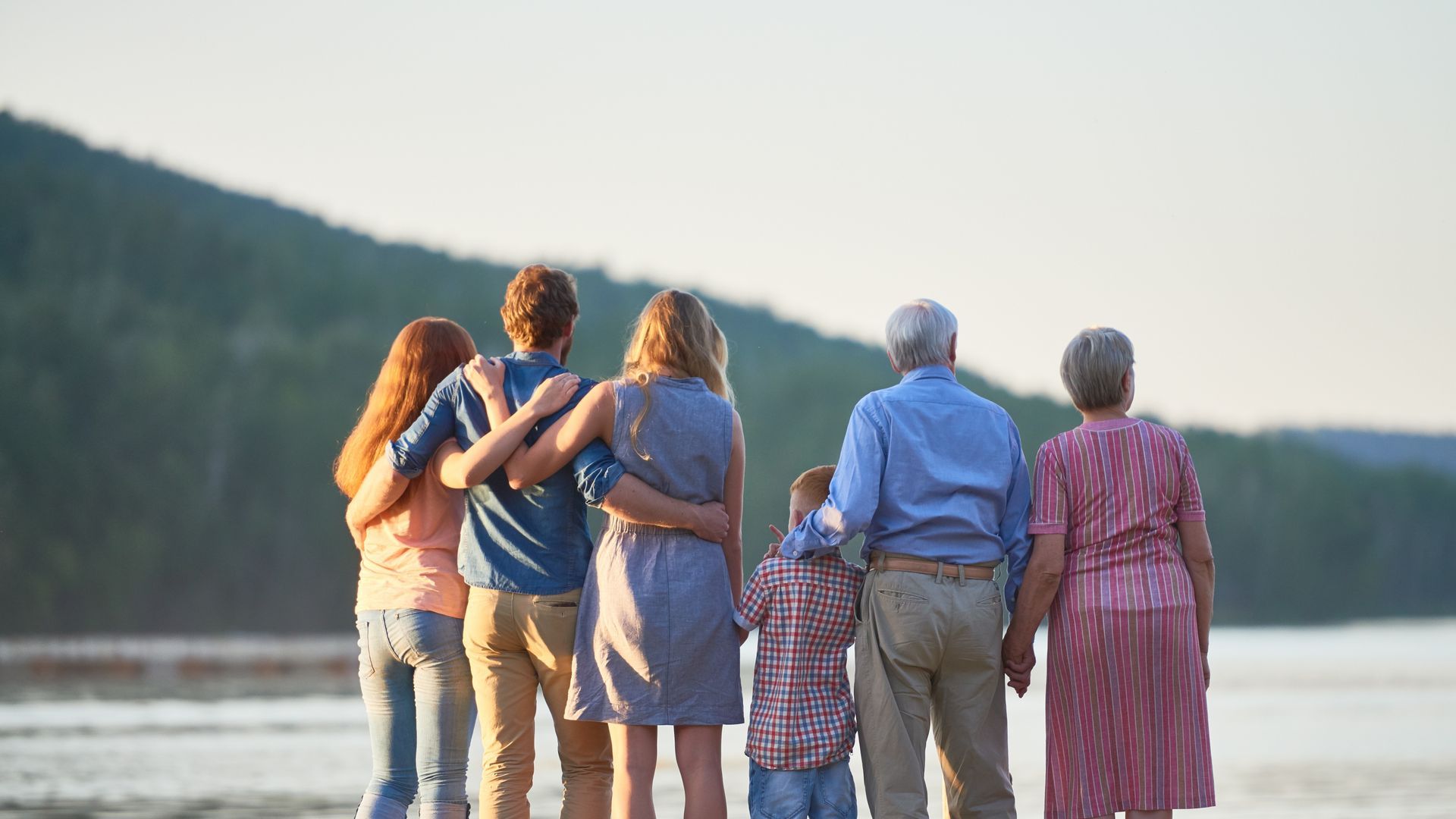 Two people reviewing documents in an office, one pointing at paper, the other gesturing.