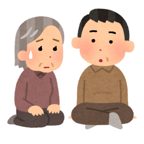 Person in red blazer holding a pen and phone, looking at a miniature house on a desk with documents.