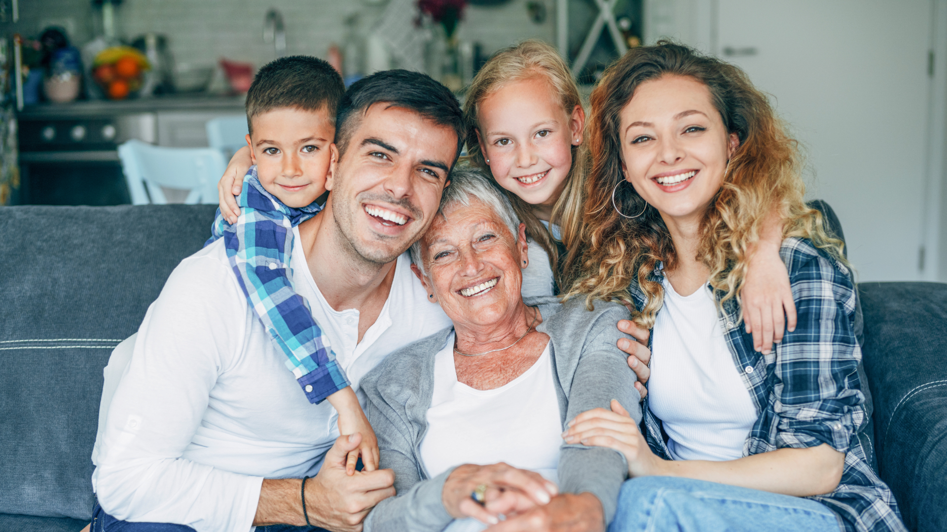 Two people in suits shaking hands over a table with documents.