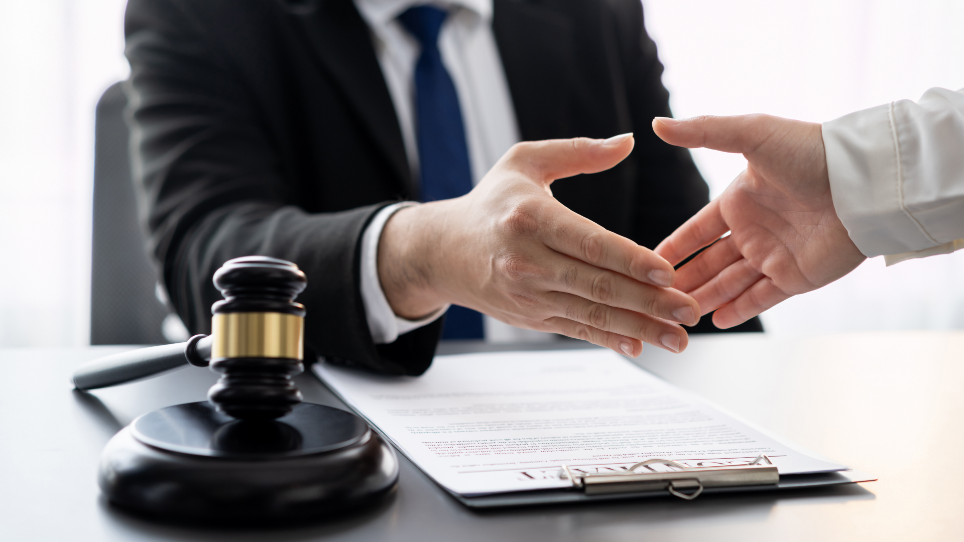 Doctor showing clipboard to patient on a couch in a well-lit office.