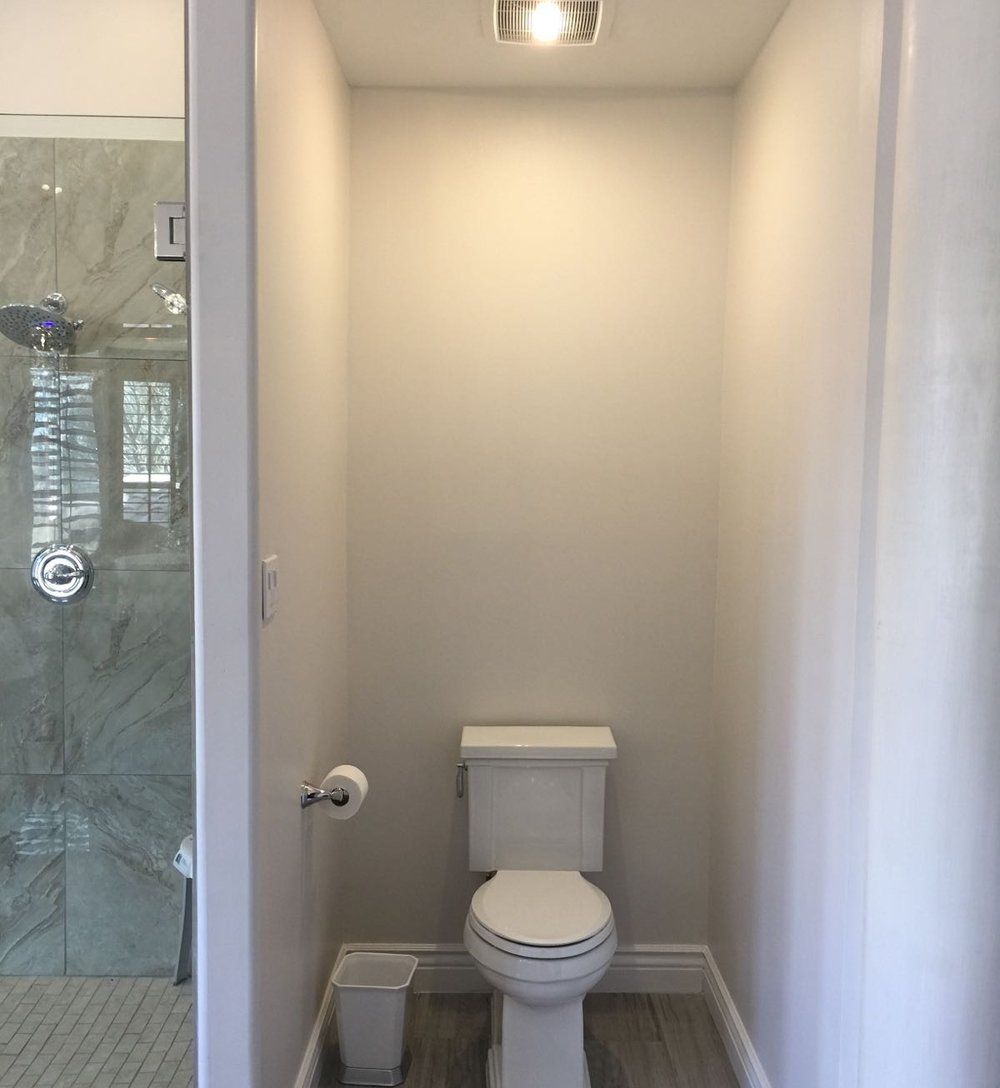 A small bathroom with a toilet and a shower