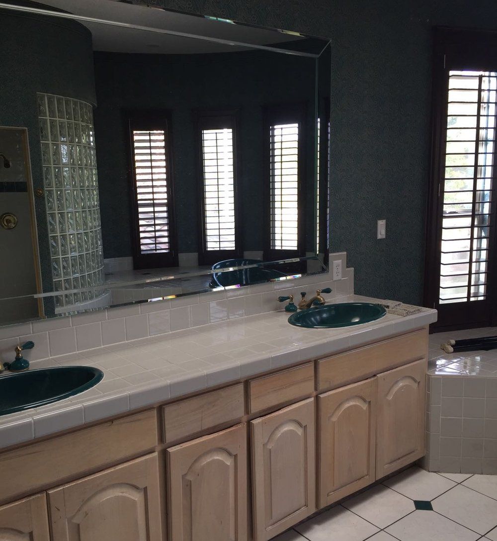 A bathroom with two sinks and a large mirror